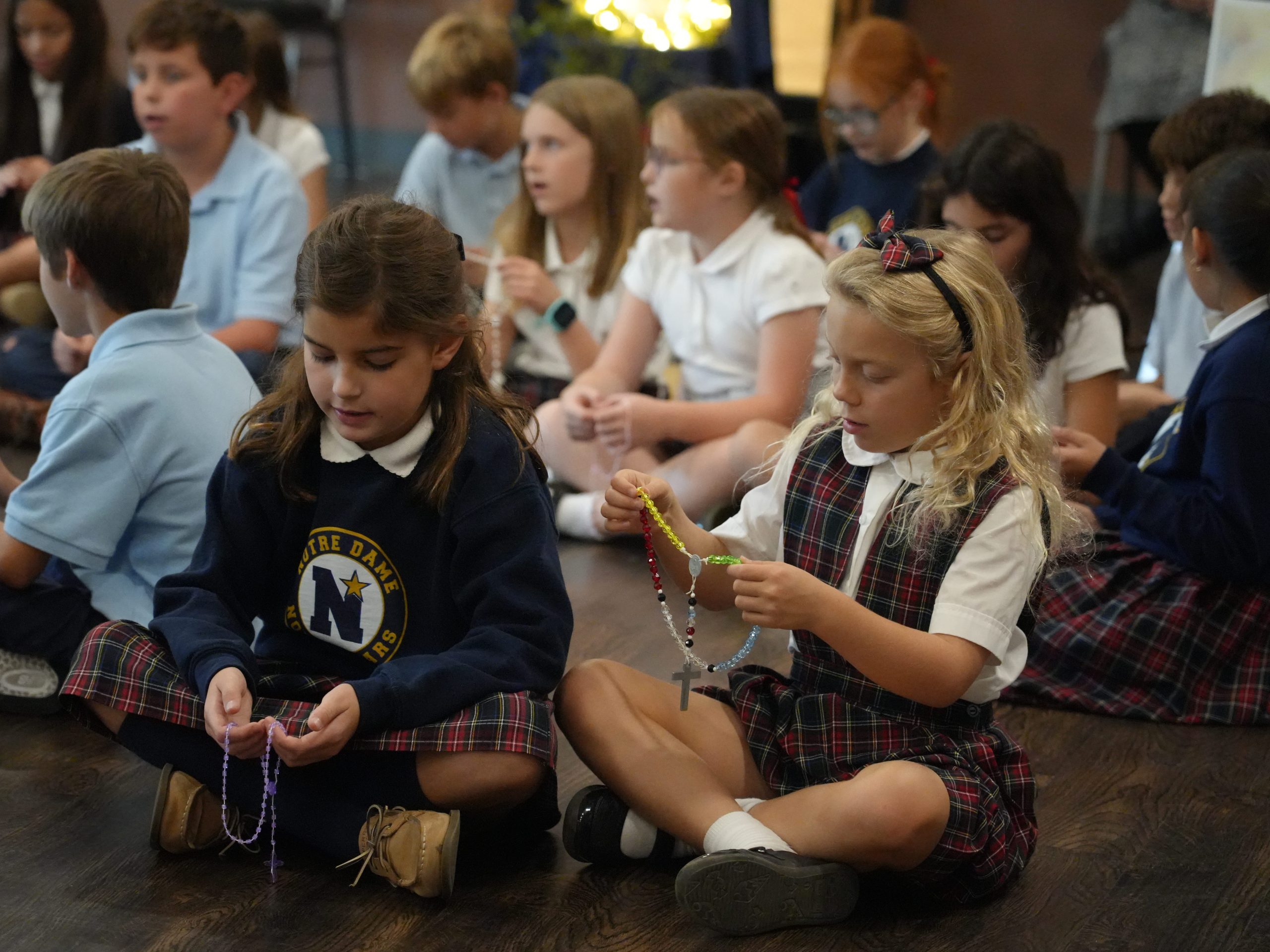 School students praying the rosary together.